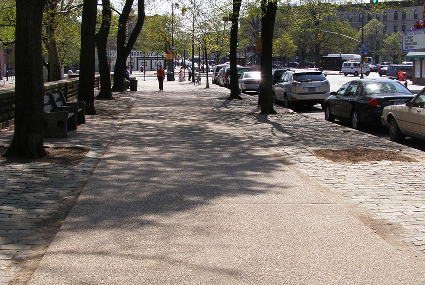 Sand-colored concrete sidewalk with exposed aggregate: Prospect Park West, Brooklyn