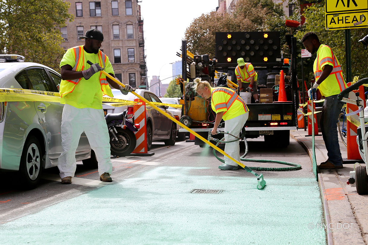 Crew painting a bike lane