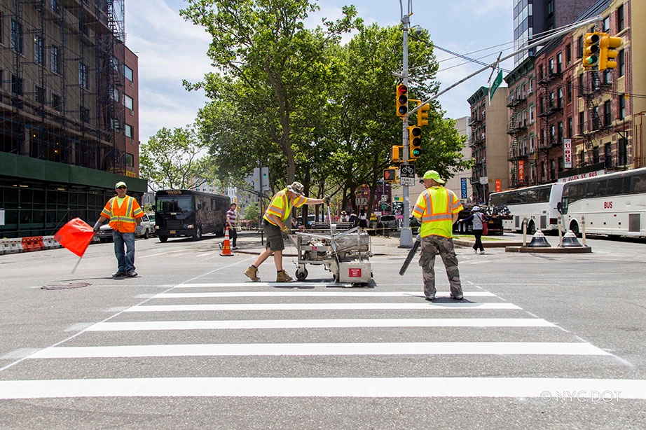 Crew painting crosswalk in the roadway