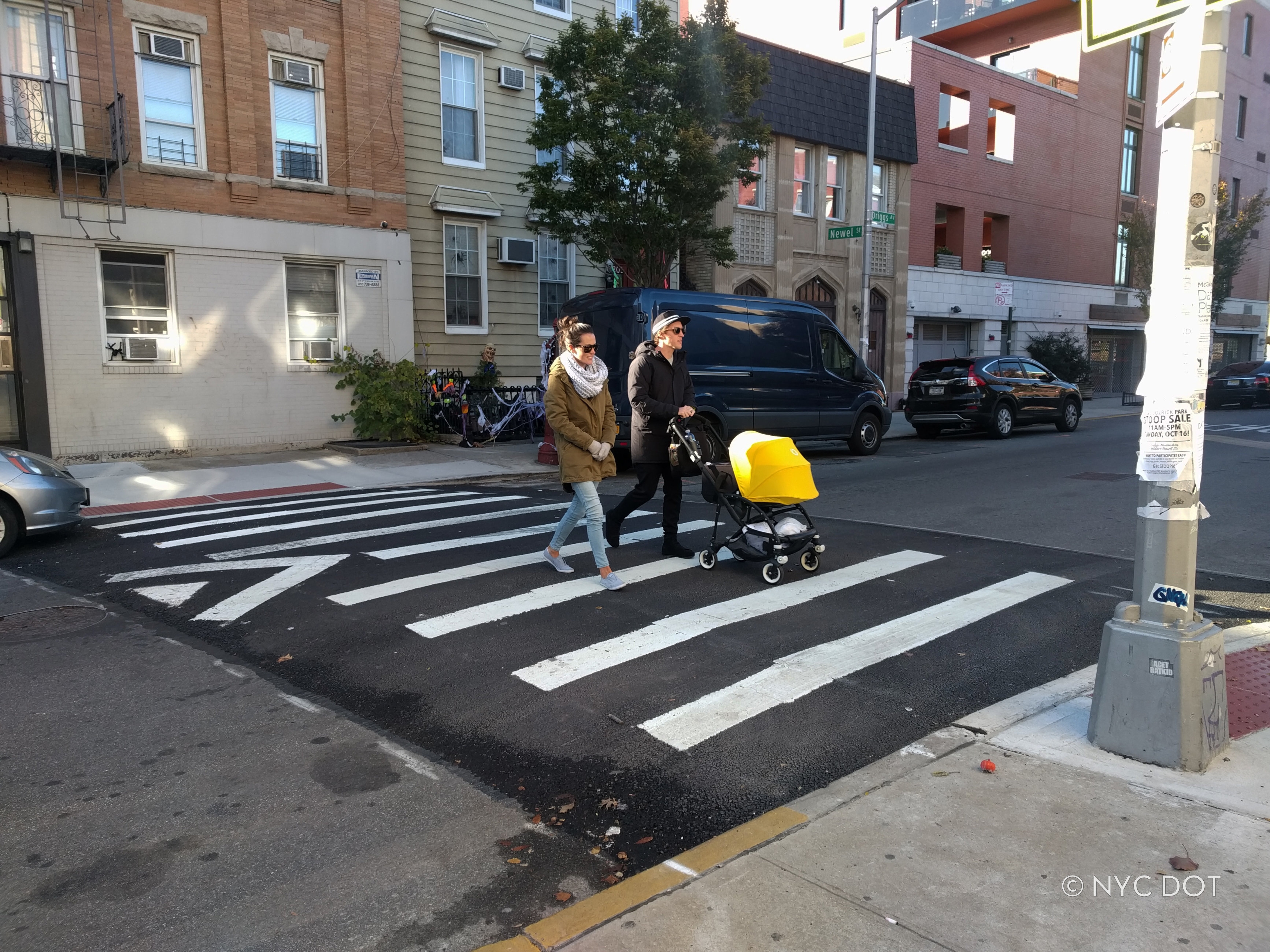 Couple with stroller crossing the street