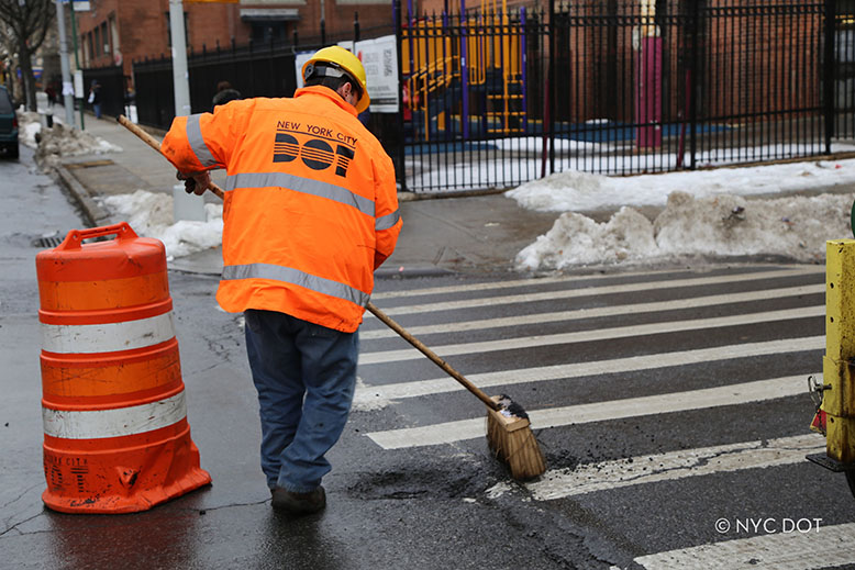 Sweeping area near filled pothole